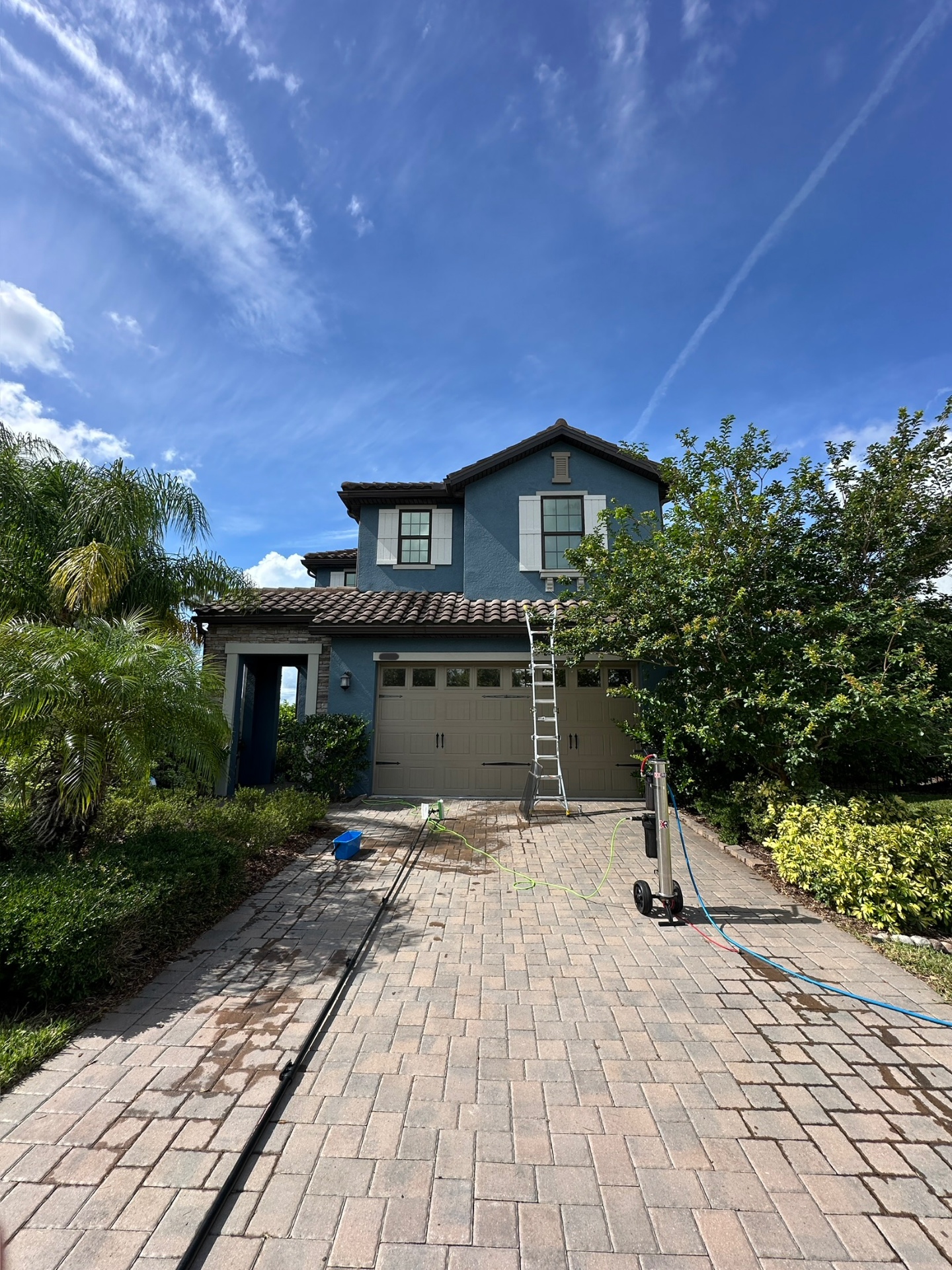 Two-story exterior — soft wash & window cleaning in progress